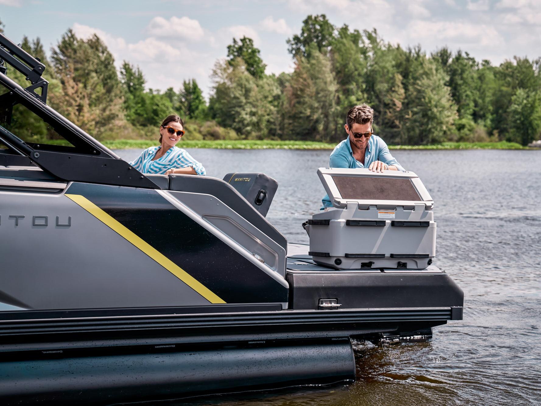Passenger using a cooler on their 2023 Manitou Explore pontoon boat