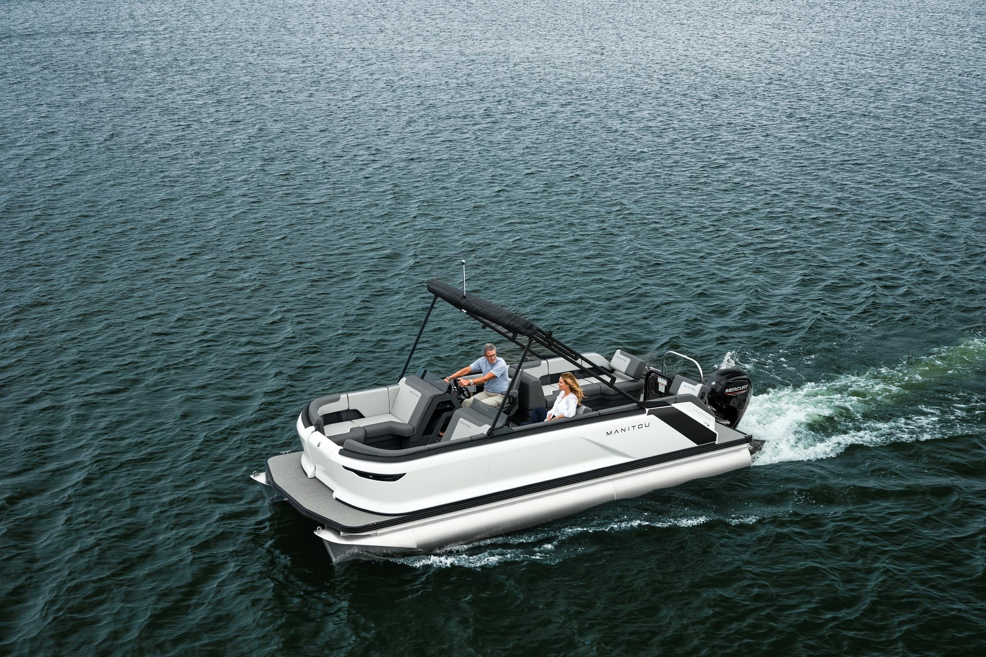 A couple silonning a large lake aboard a Manitou Cruise